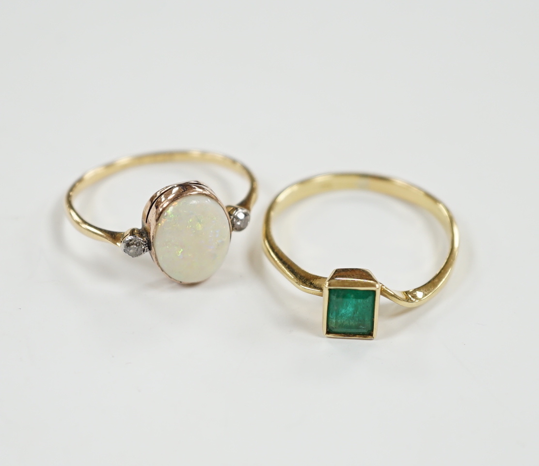 An 18ct & plat, white opal and two stone diamond set ring, size O and an 18k and single stone emerald ring, gross weight 4.1 grams.